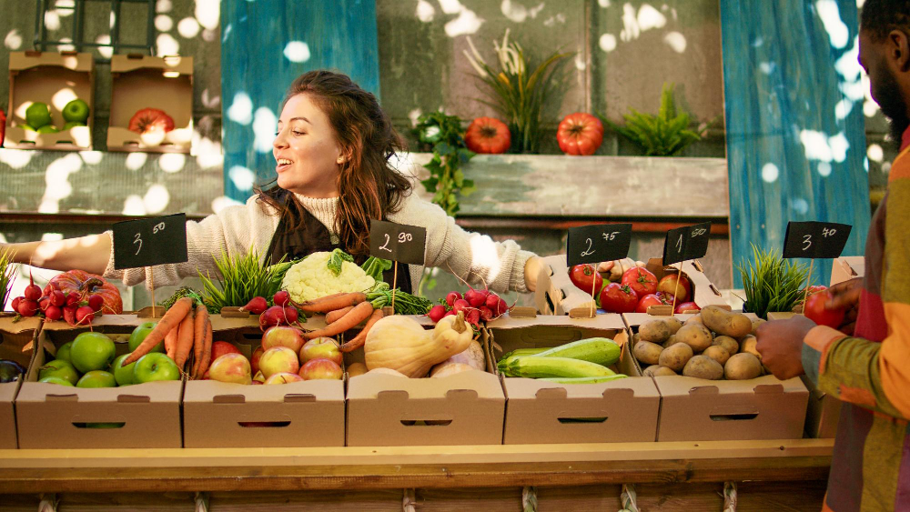 people-enjoying-shopping-local-farmers-market-checking-fresh-farm-produce-young-diverse-couple-standing-farming-stand-with-various-homegrown-organic-fruits-vegetables